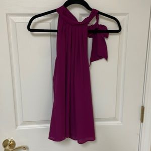 Express ladies blouse. Polyester. Sleeveless w/ ribbon to tie off the shoulder.